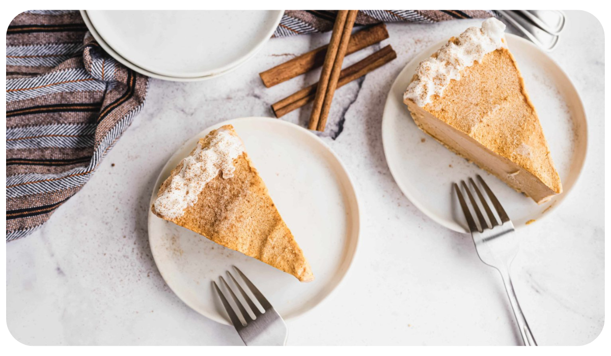 Two white plates, each with a piece of delicious pumpkin praline cheesecake.