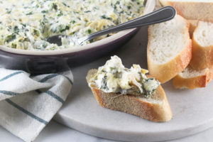 Spinach Artichoke Dip with a side of bread slices
