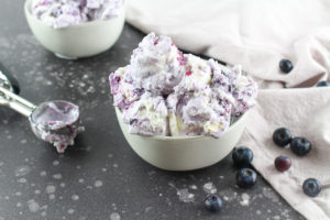 Blueberry Cheesecake Gelato in a bowl surrounded by blueberries