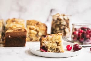 Cranberry and Almond Mascarpone Cake on a plate with cranberries