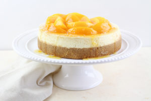 Peaches and Cream Cheesecake on a white serving plate
