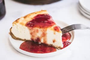 Skinny Cheesecake with strawberry sauce on it