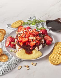 Strawberry Baked Brie on a plate with crackers