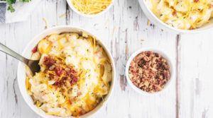 Cheesy Potato Soup in a bowl with a side of bacon bits