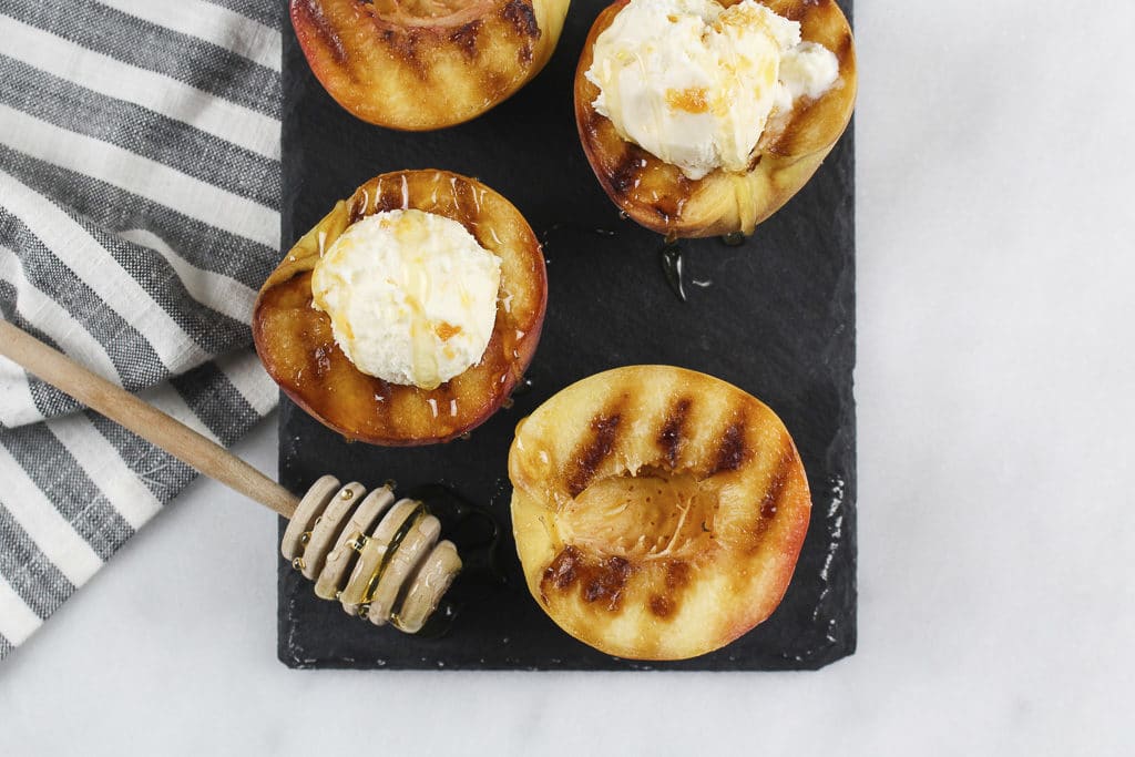 grilled fruit with ice cream and caramel drizzle on top