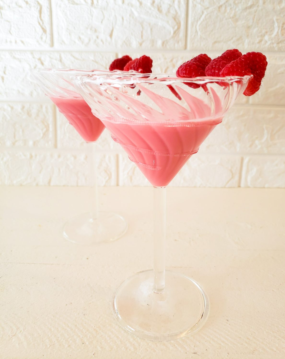 tropical raspberry cocktail in a martini glass