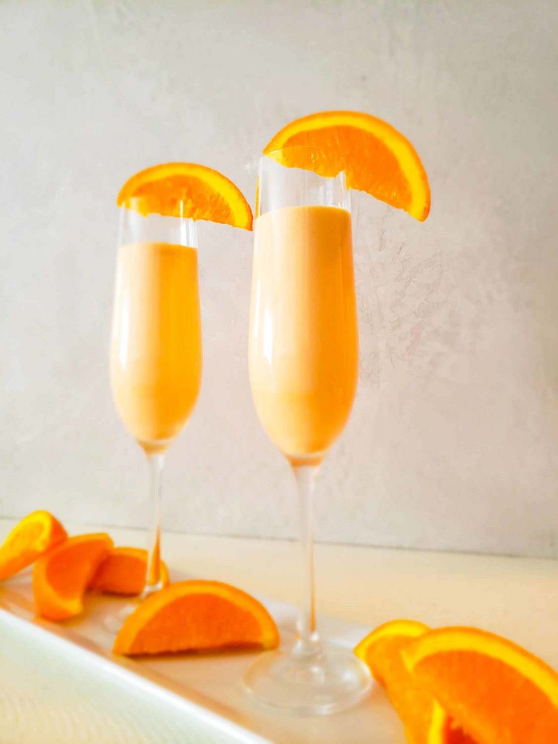 orange cocktail in a champagne glass