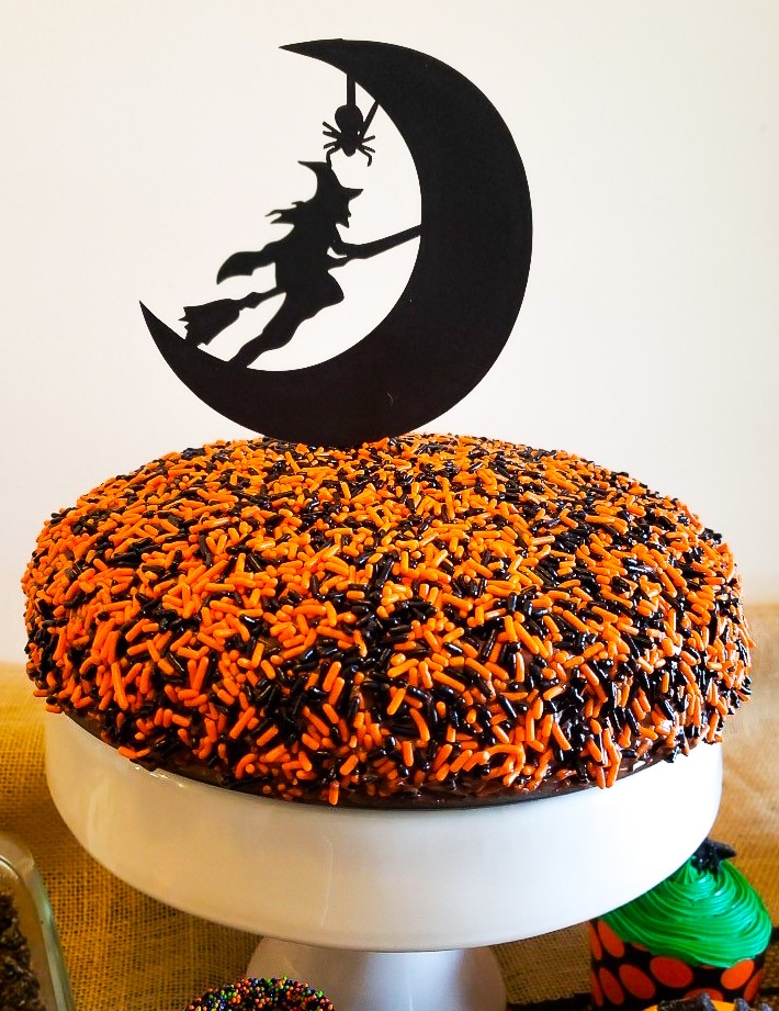 cake topped with chocolate frosting and a halloween deocration