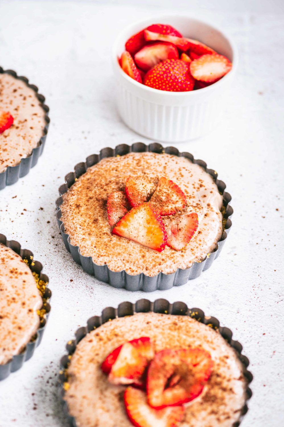 mini tarts with strawberries on top