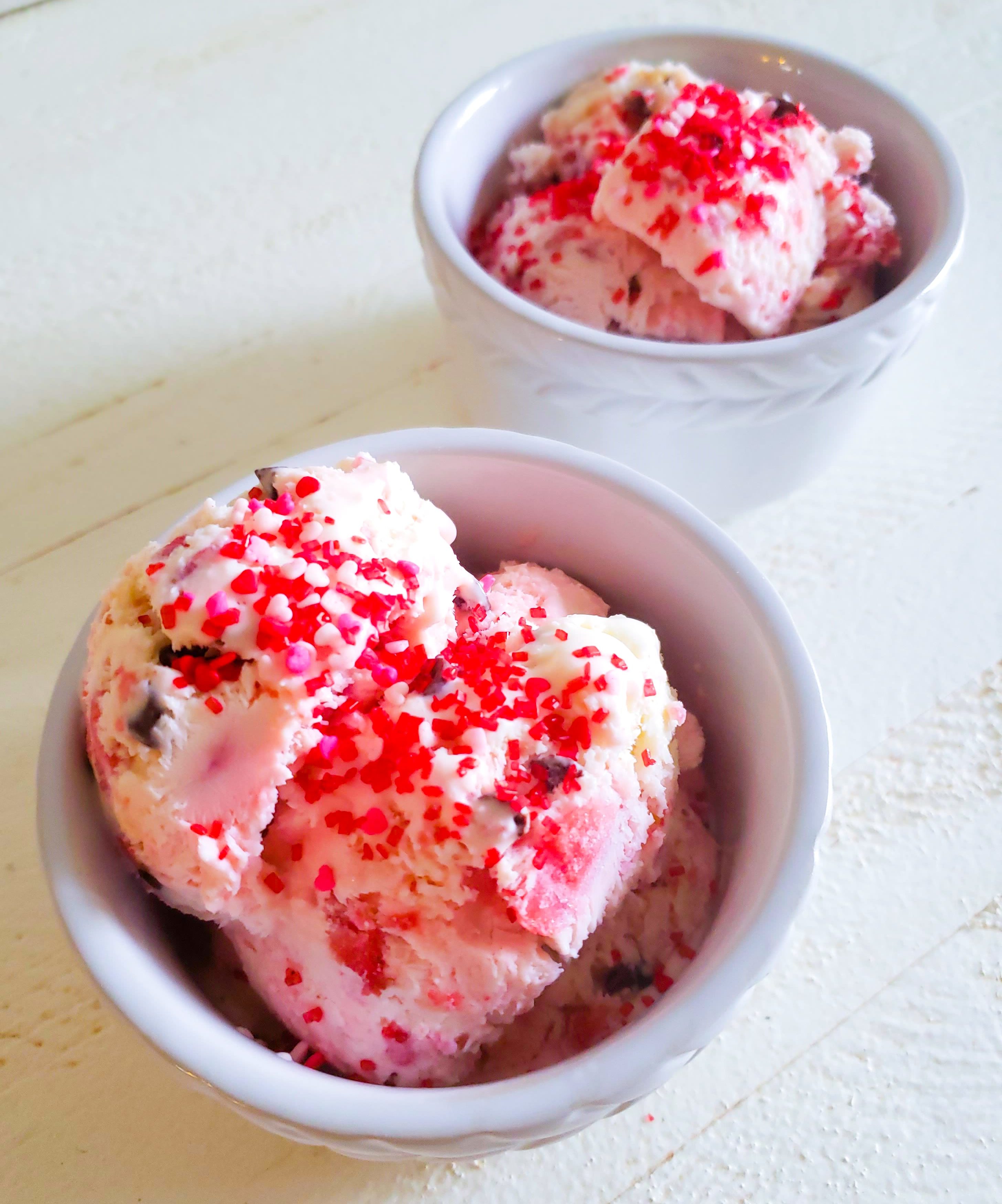 pink ice cream topped with red sprinkles