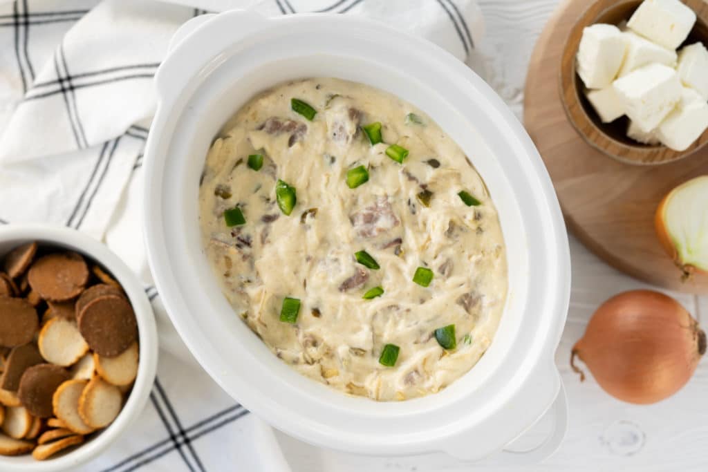 Slow Cooker Cheesesteak Dip in a white slow cooker