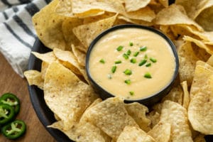 Slow Cooker Queso in a dish surrounded by chips