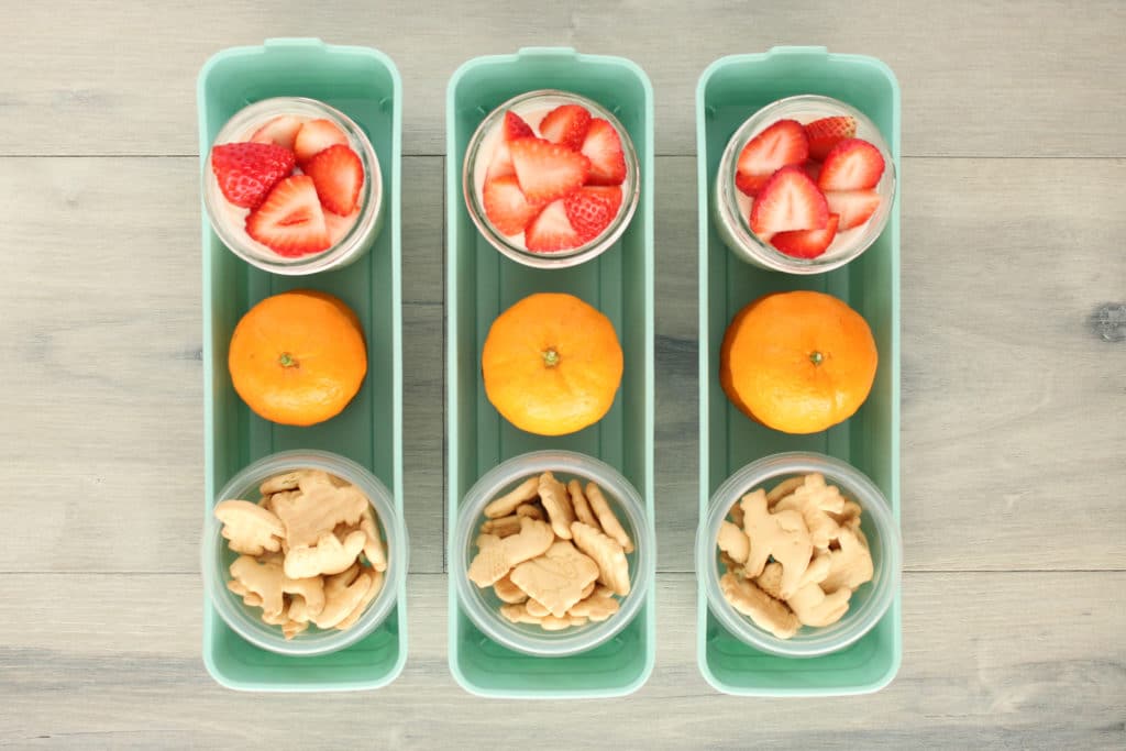 Individual Snack Bins with animal crackers, an orange and strawberry slices