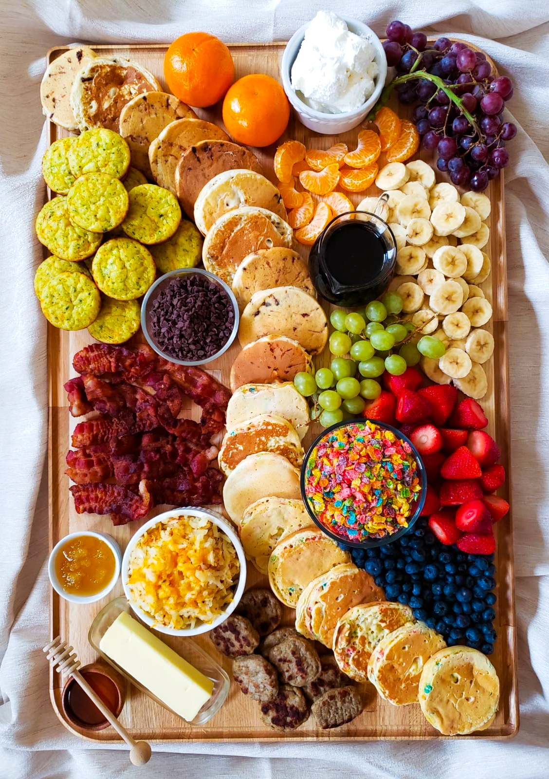 a beautiful charcuterie board with an assortment of breakfast foods