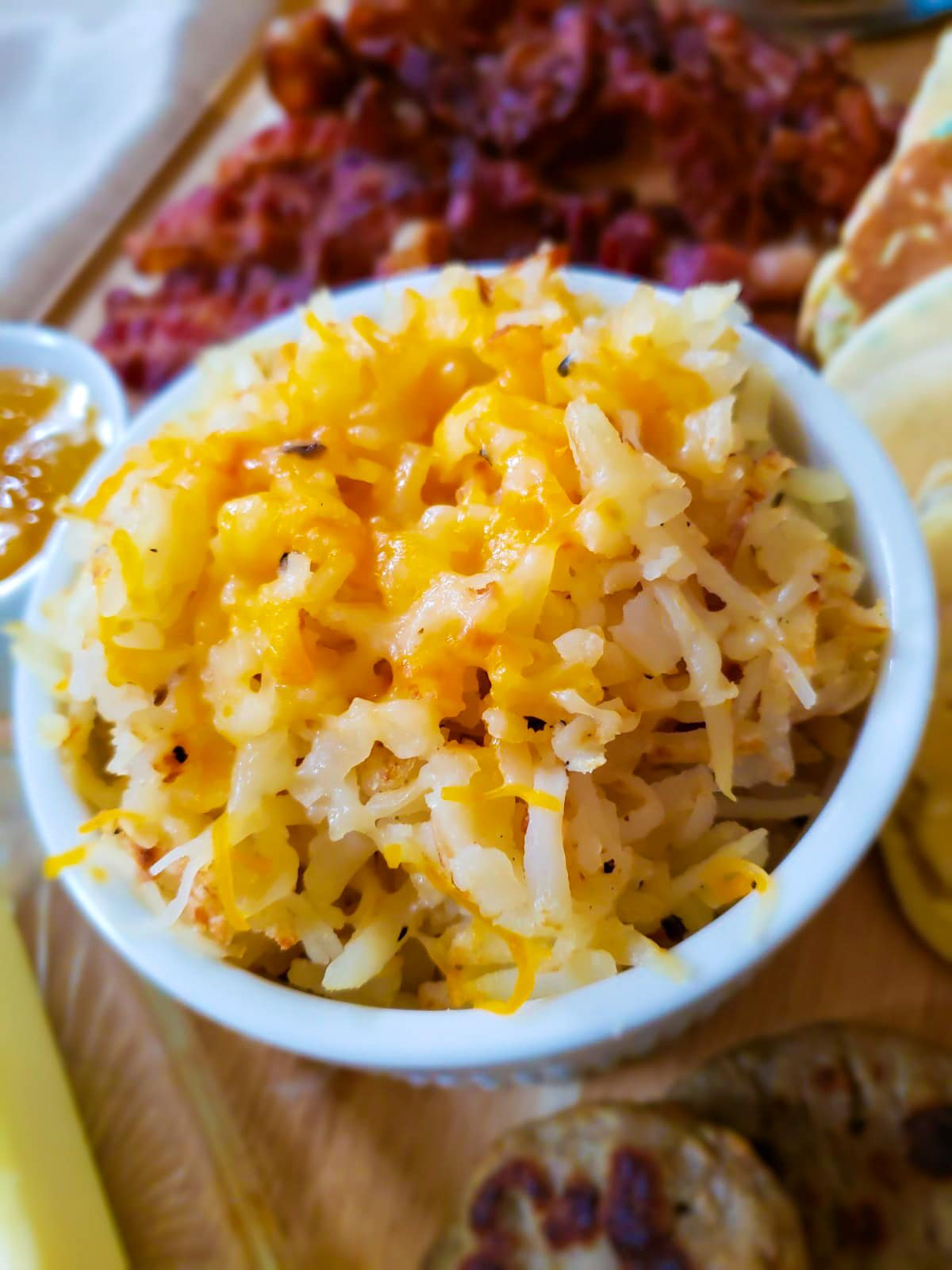 close up photo of cheese topped hashbrowns