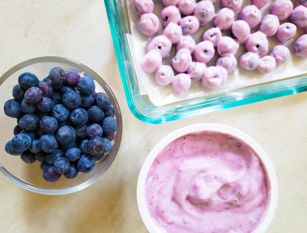 blueberries and yogurt and a plate of them dipped in yogurt
