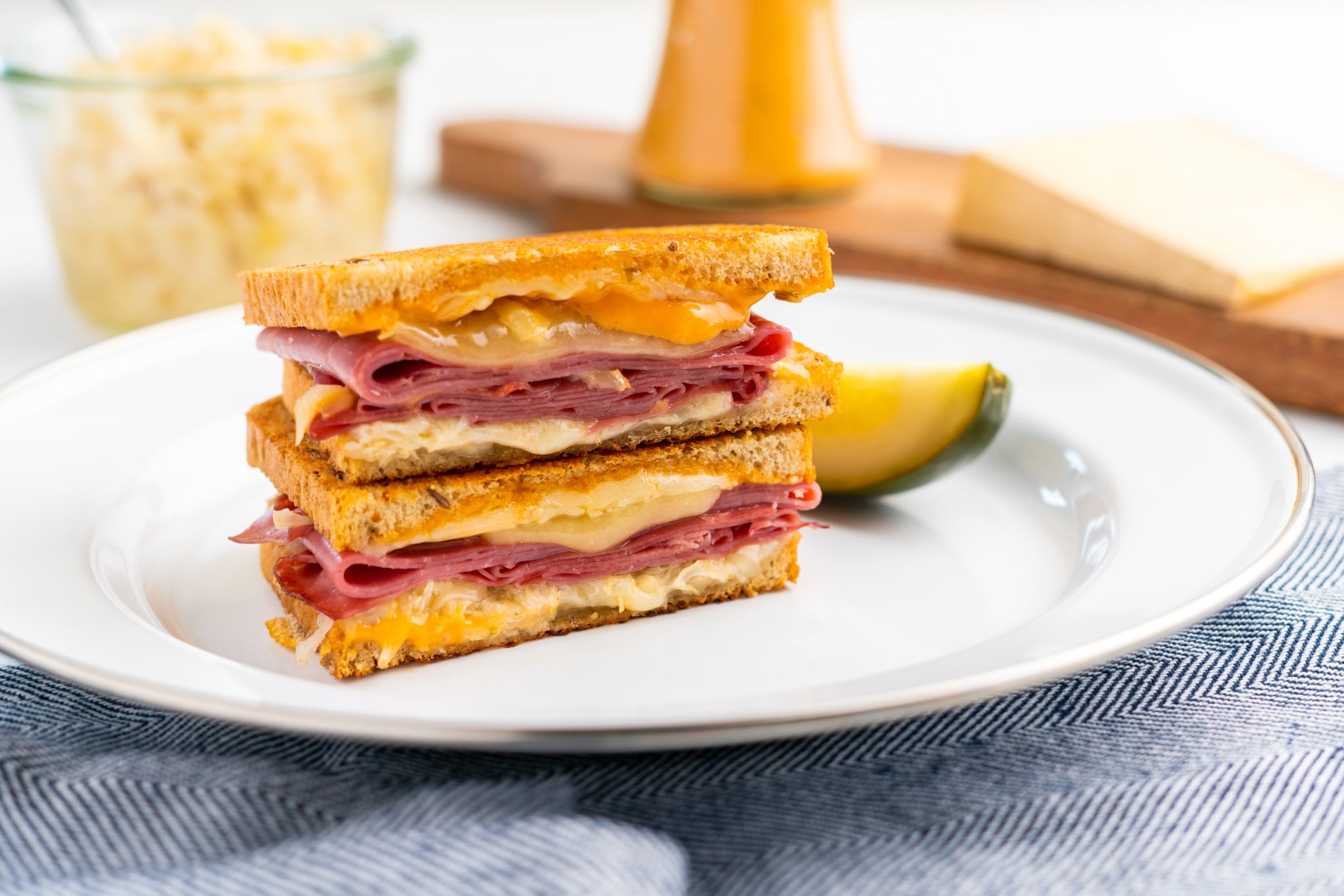 reuben grilled cheese on a plate with a pickle