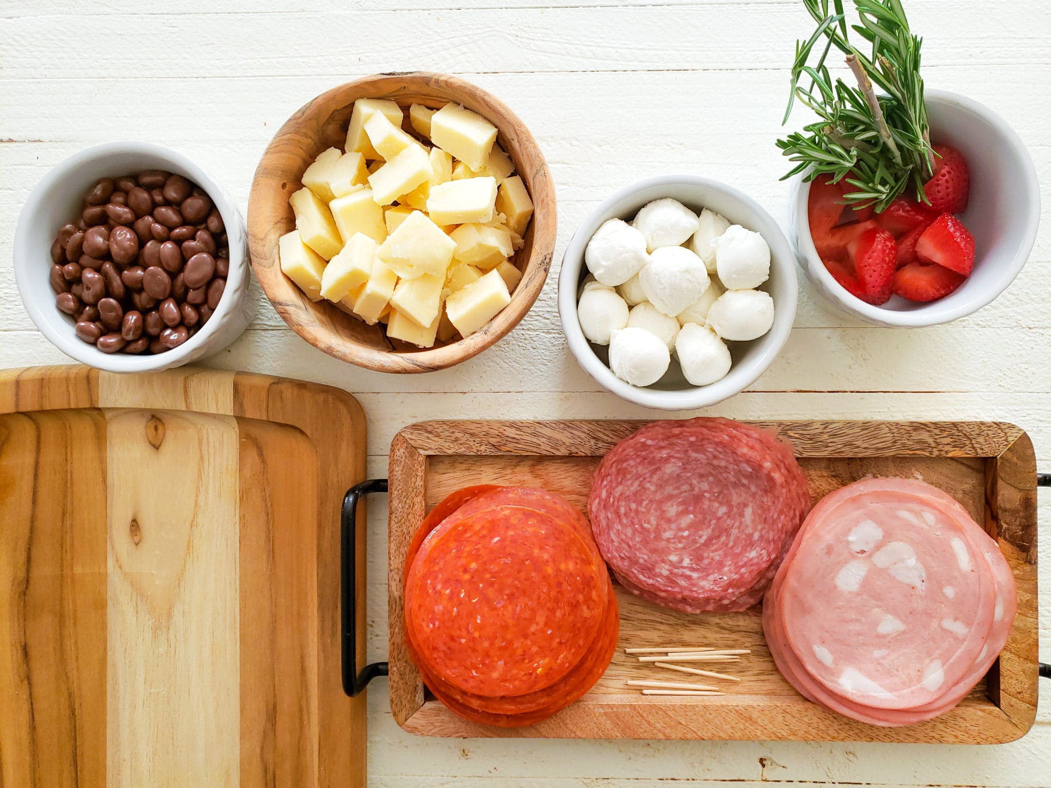 an assortment of charcuterie board ingredients in separate dishes