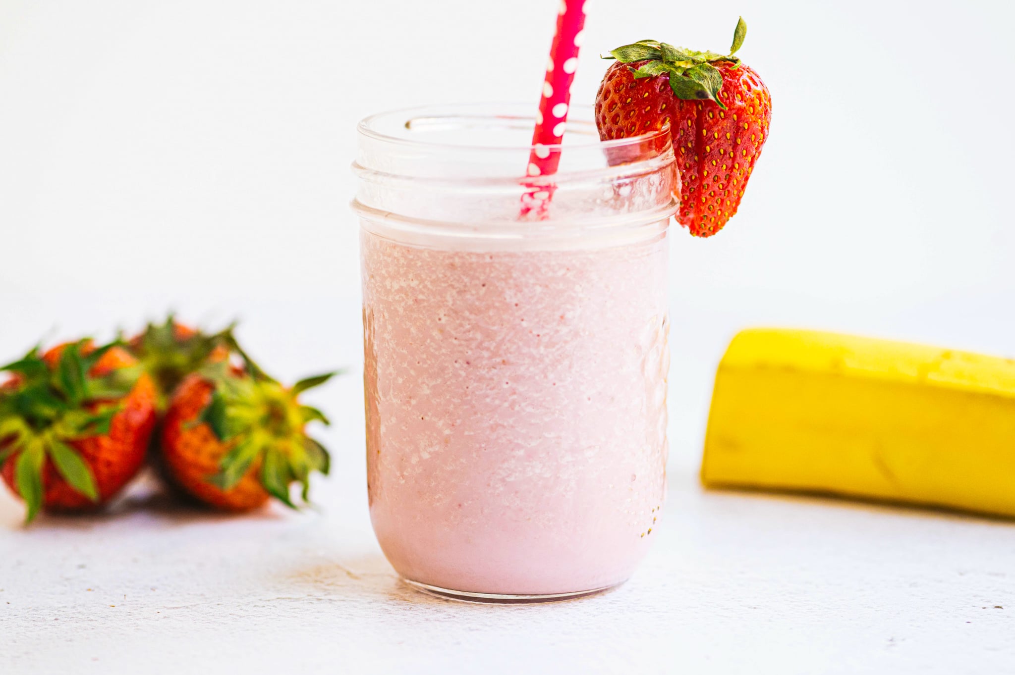 strawberry banana milk in a small mason jar