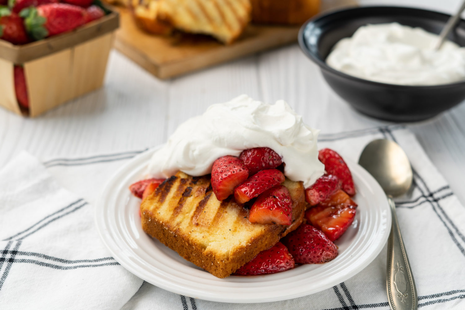 grilled pound cake with strawberries and whipped cream on top