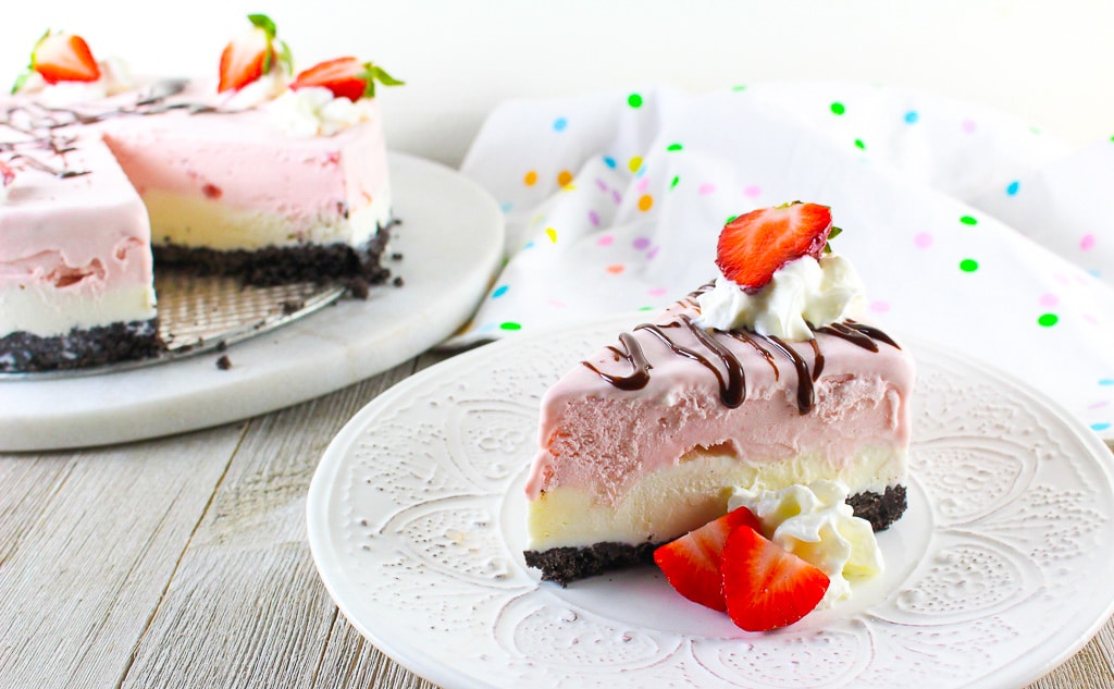 ice cream cake slices topped with whipped cream and strawberries