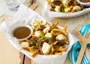 Cheese Curd Poutine with Roast Beef served in a basket