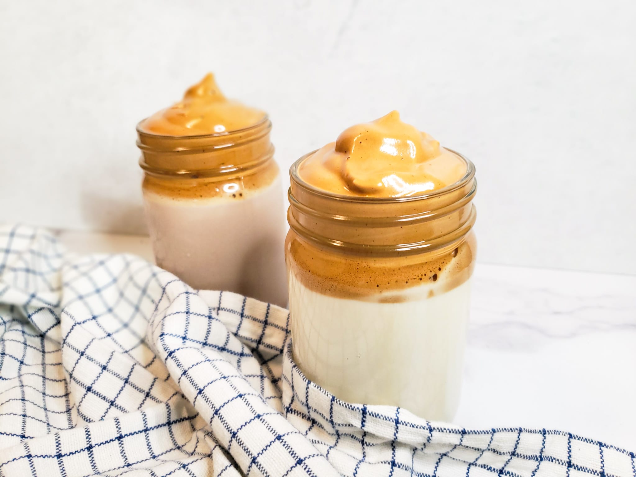 mason jars full of milk and topped with whipped coffee