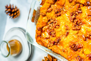 Sweet Potato Bread Pudding in a glass baking dish with pecans on top