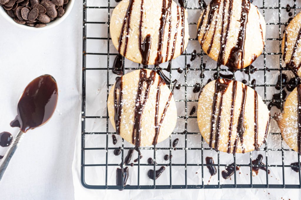 fancy chocolate chip cookies with chocolate drizzled on top