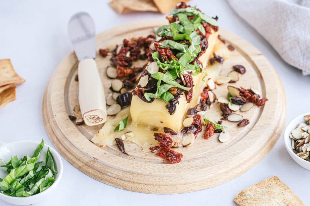 baked cheddar with nuts and dried berries on top