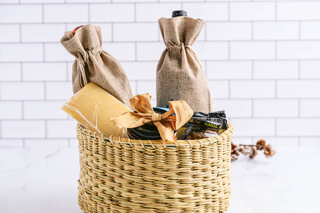Beautiful basket filled with cheese and wine, ready to be gifted.