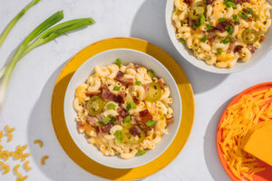 A stylish white plate of creamy microwave bacon jalapeno mac and cheese bowl.