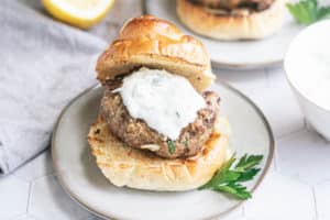 Lamb hamburger served on a handcrafted white dish