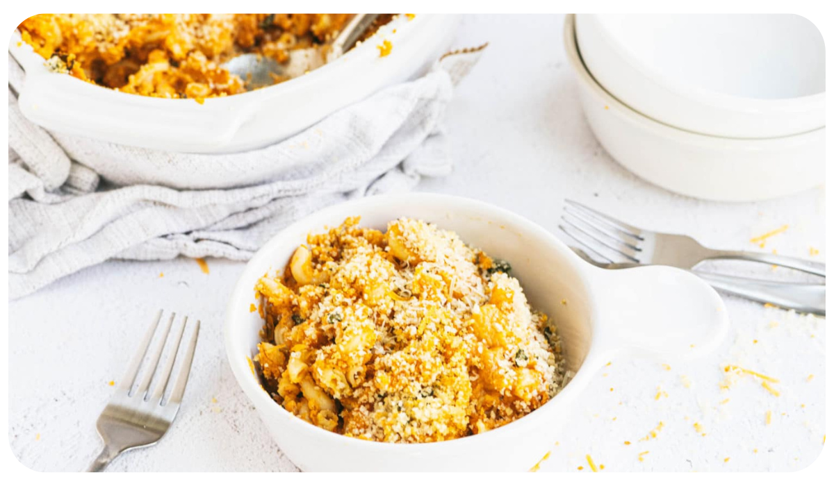 Delicious pumpkin mac and cheese served in a white bowl, sprinkled with breadcrumbs over the top.